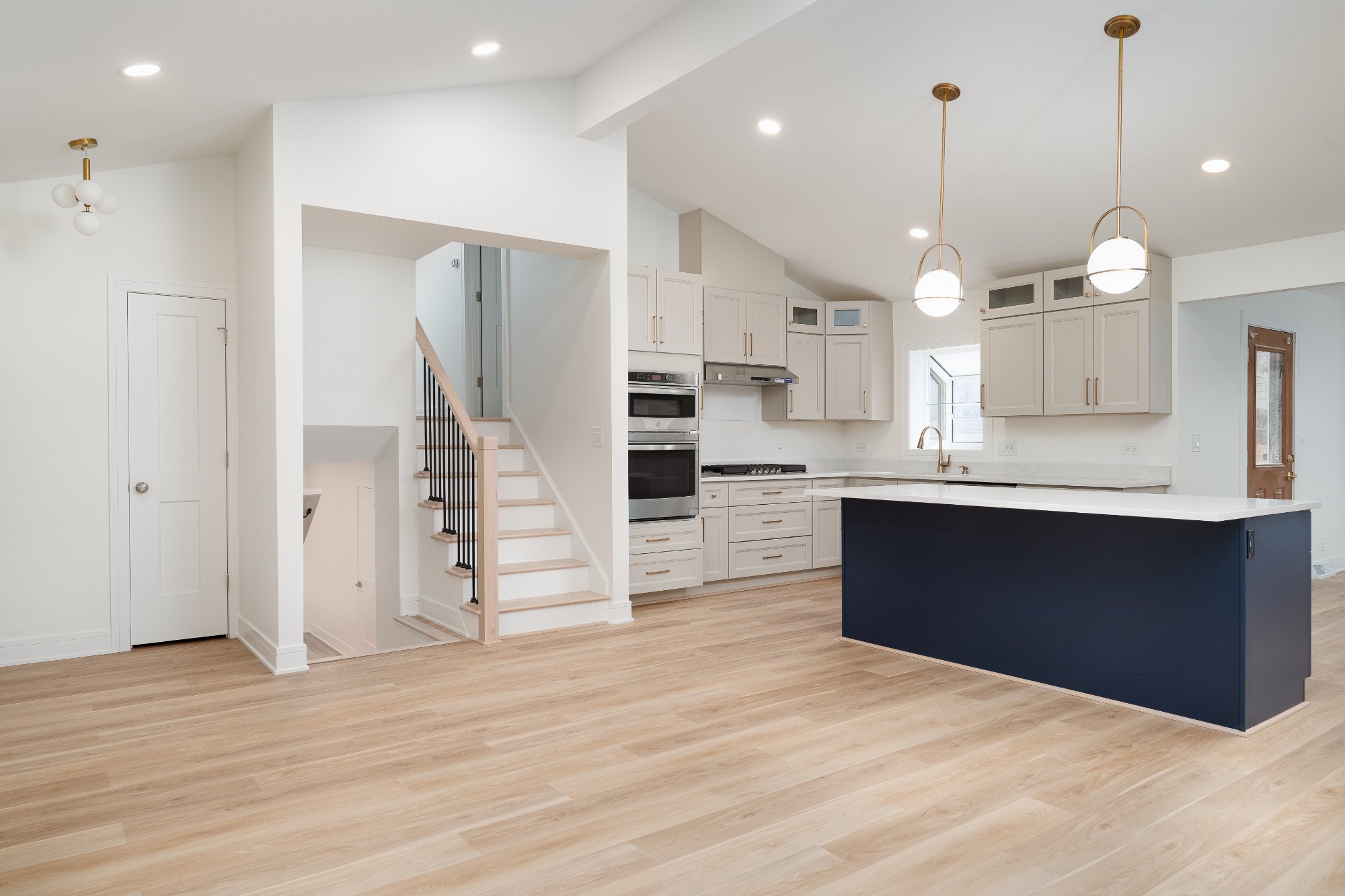 Open-concept kitchen renovation in Arlington Heights, IL completed by Skor Construction showcasing hardwood floors and custom na-optimized