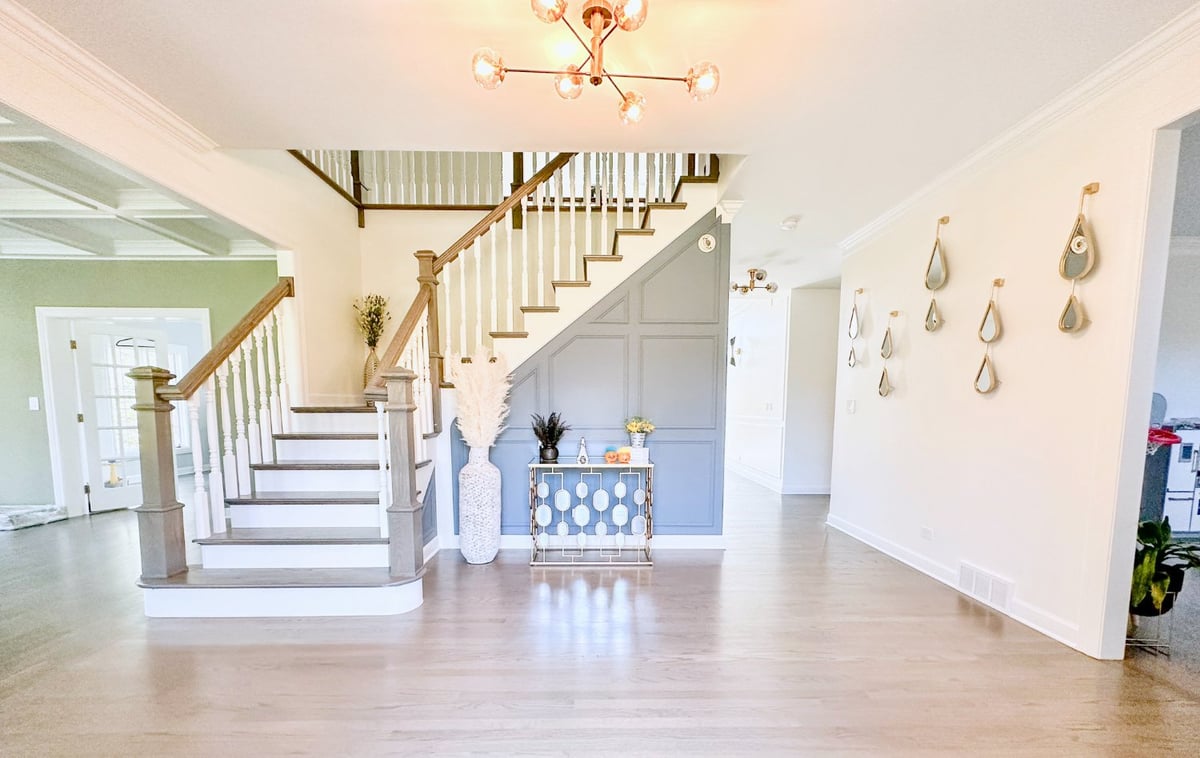 grand foyer with custom staircase, accent wall, and modern lighting in a whole house remodel by Skor Construction in Barrington,-optimized