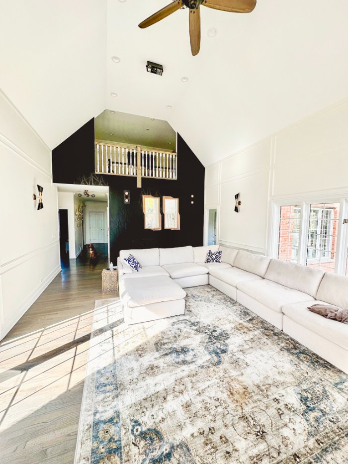 remodeled family room featuring soaring ceilings, custom wall detailing, and abundant natural light by Skor Construction in Barr-optimized