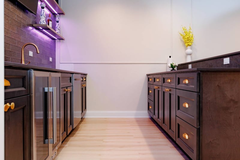 luxury basement bar renovation featuring custom cabinets, stone countertops, and accent lighting by Skor Construction in Palatin-optimized