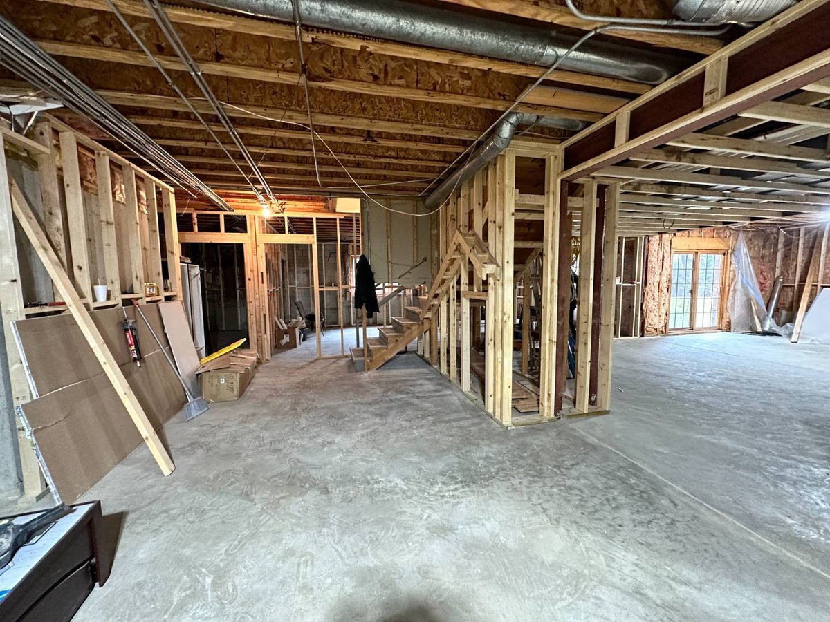 unfinished basement renovation featuring framed rooms, exposed mechanicals, and future recreation space by Skor Construction in -optimized