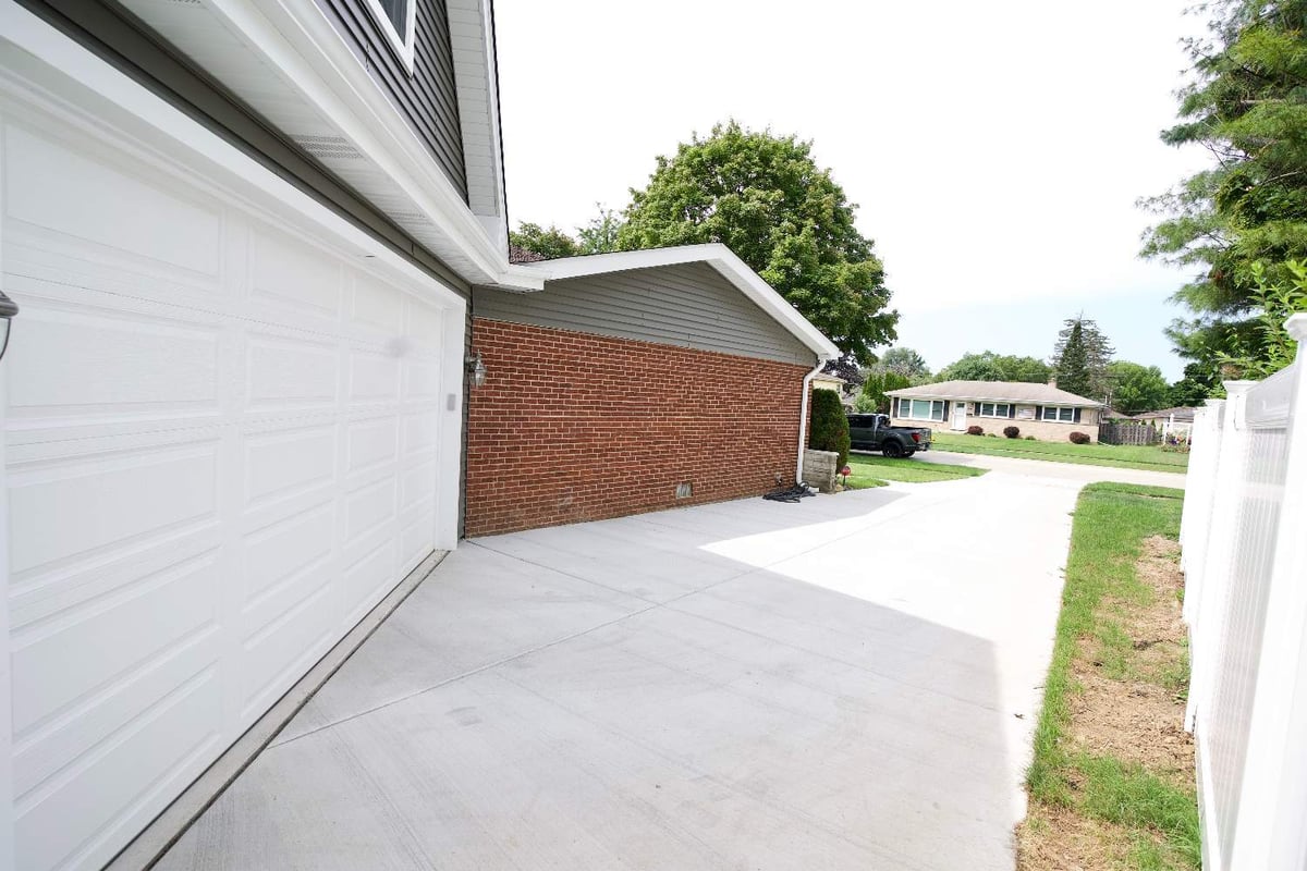newly installed concrete driveway and garage addition by Skor Construction in Mount Prospect, IL with upgraded exterior finishes-optimized