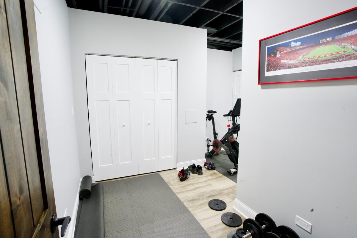 finished basement fitness area by Skor Construction in Hoffman Estates, IL with exercise equipment storage and contemporary desi-optimized