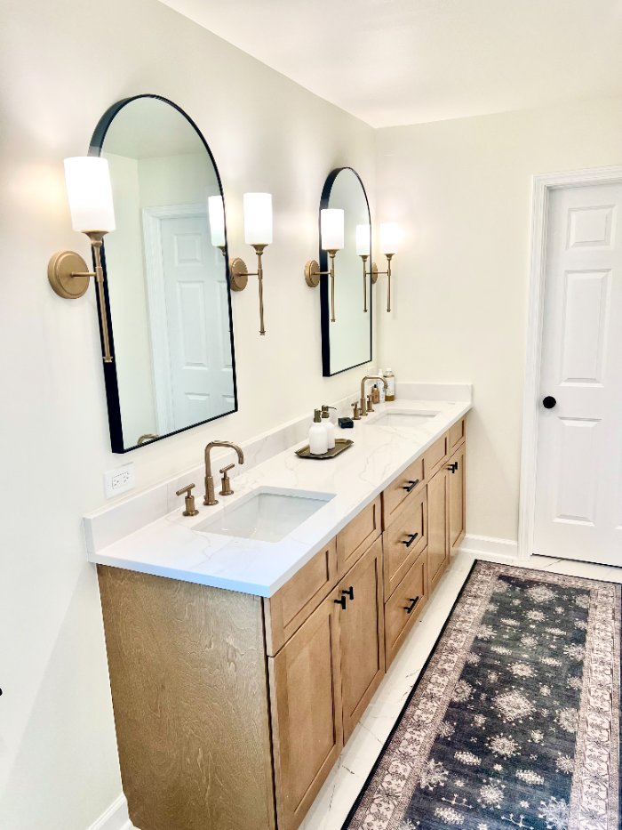 luxury bathroom renovation by Skor Construction in Palatine, IL showcasing arched mirrors, brushed brass fixtures, and custom st-optimized