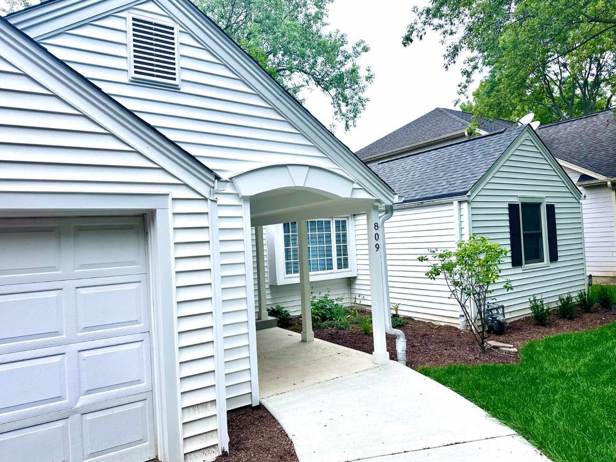 front facade view of a residence in Wilmette, IL prior to a sunroom addition and outdoor living renovation by Skor Construction.-optimized