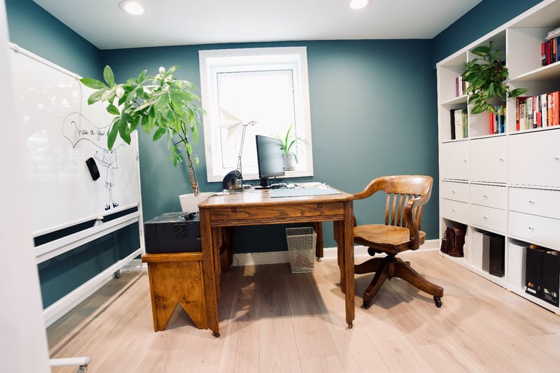 remodeled basement office with built-in shelving, modern flooring, and workspace by Skor Construction in Mount Prospect, IL