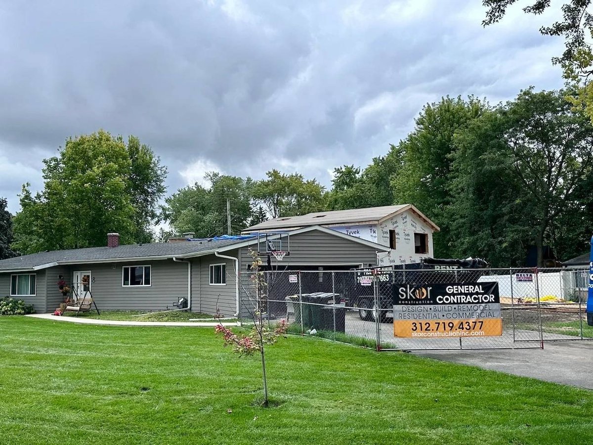 Exterior view of a Skor Construction home addition under construction in Palatine, IL with new framing and expanded living space-optimized