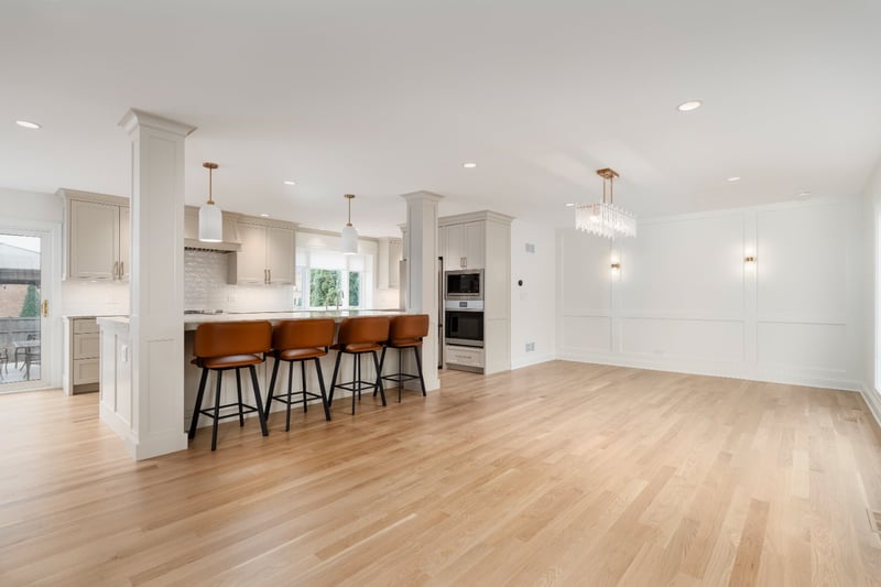 Luxury main level remodel by Skor Construction in Mount Prospect, IL with custom white cabinetry, modern lighting, and open dini-optimized