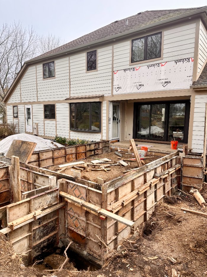 Exterior home addition construction by Skor Construction in Hawthorn Woods, IL featuring new 3 seasons room foundation and siding ins-optimized