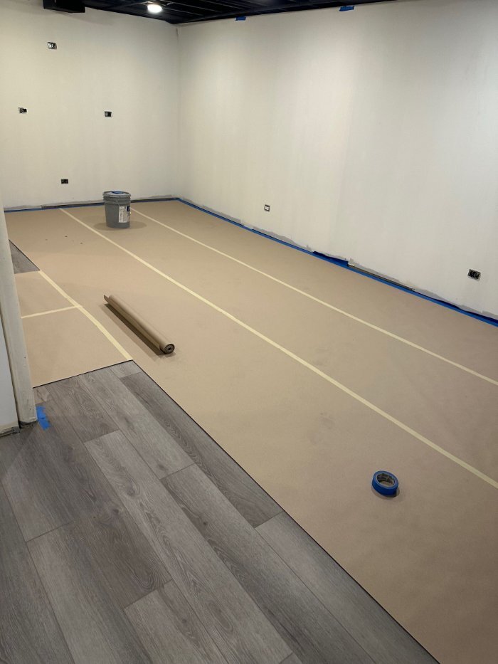 basement flooring installation by Skor Construction in Riverwoods, IL during a custom basement remodeling project.-optimized
