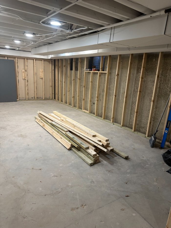 unfinished basement construction in Riverwoods, IL by Skor Construction with newly framed walls and open floor plan.-optimized