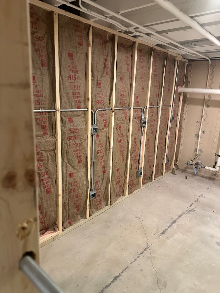 unfinished basement remodel in Riverwoods, IL by Skor Construction featuring framed walls and electrical rough-in.-optimized