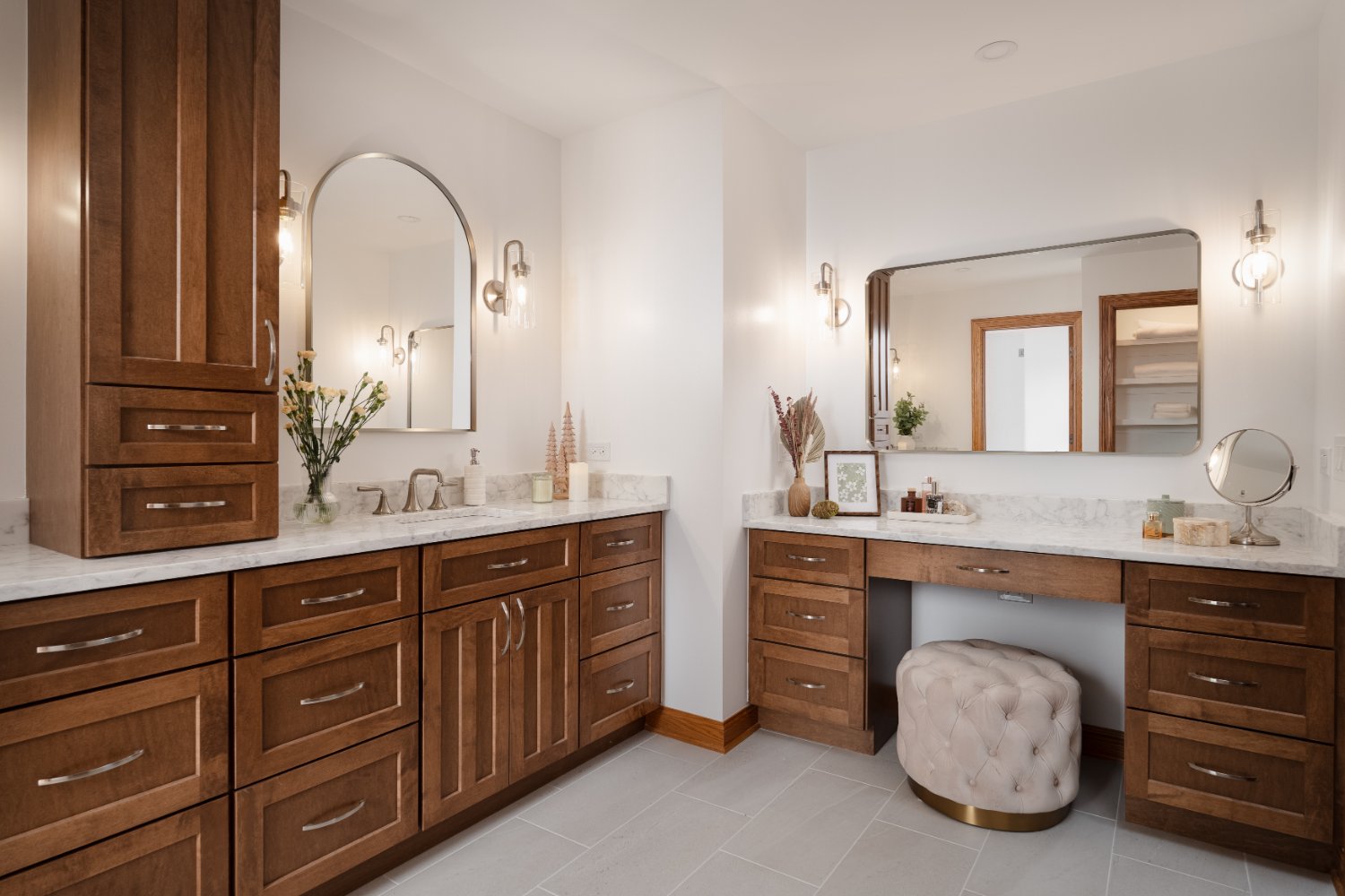 Wide view of a remodeled primary bathroom in Inverness, IL by Skor Construction featuring makeup vanity and double sinks.-optimized