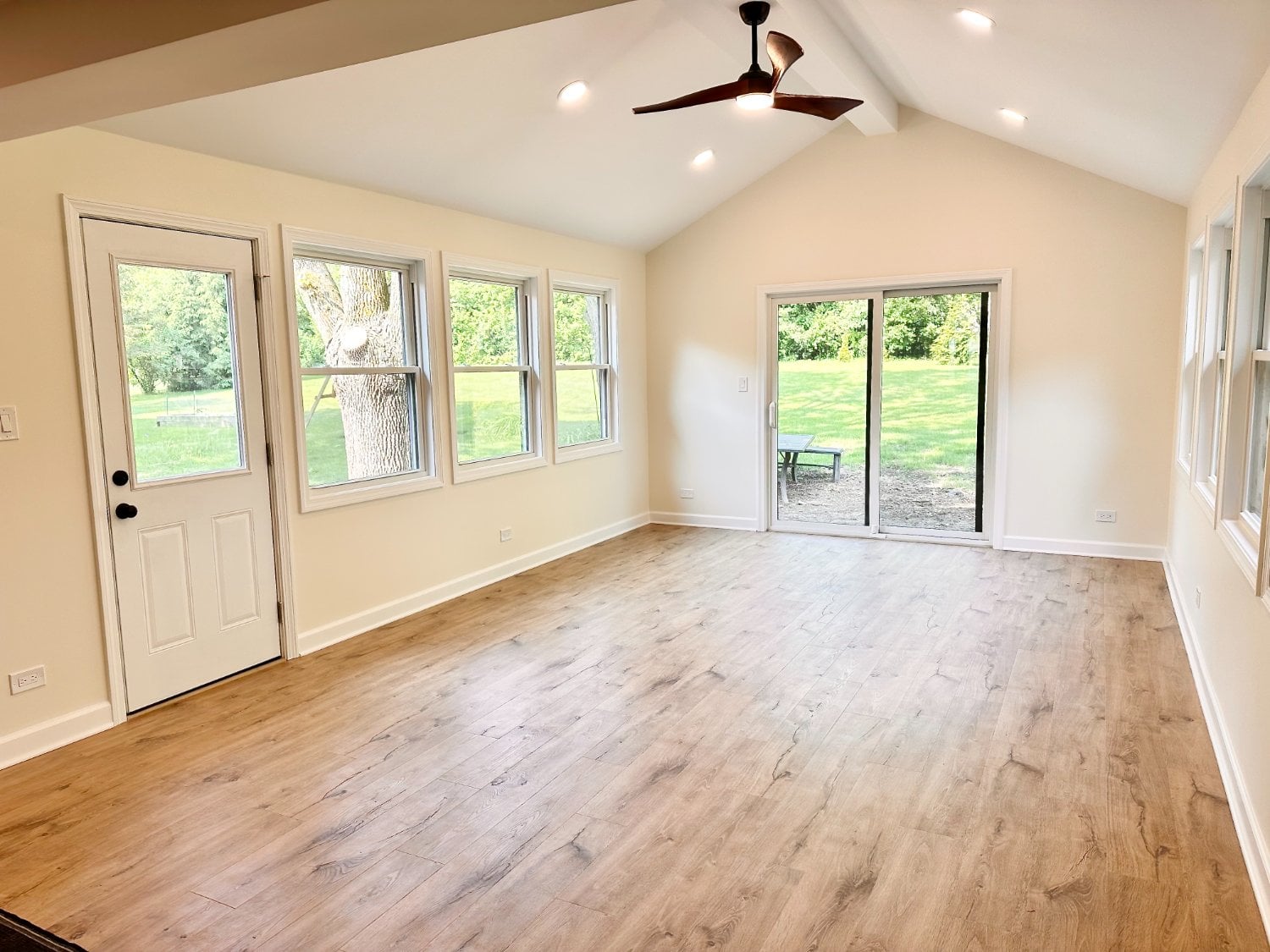 Finished 3 seasons room addition by Skor Construction in Inverness, IL featuring vaulted ceilings, luxury vinyl flooring, and sl-optimized