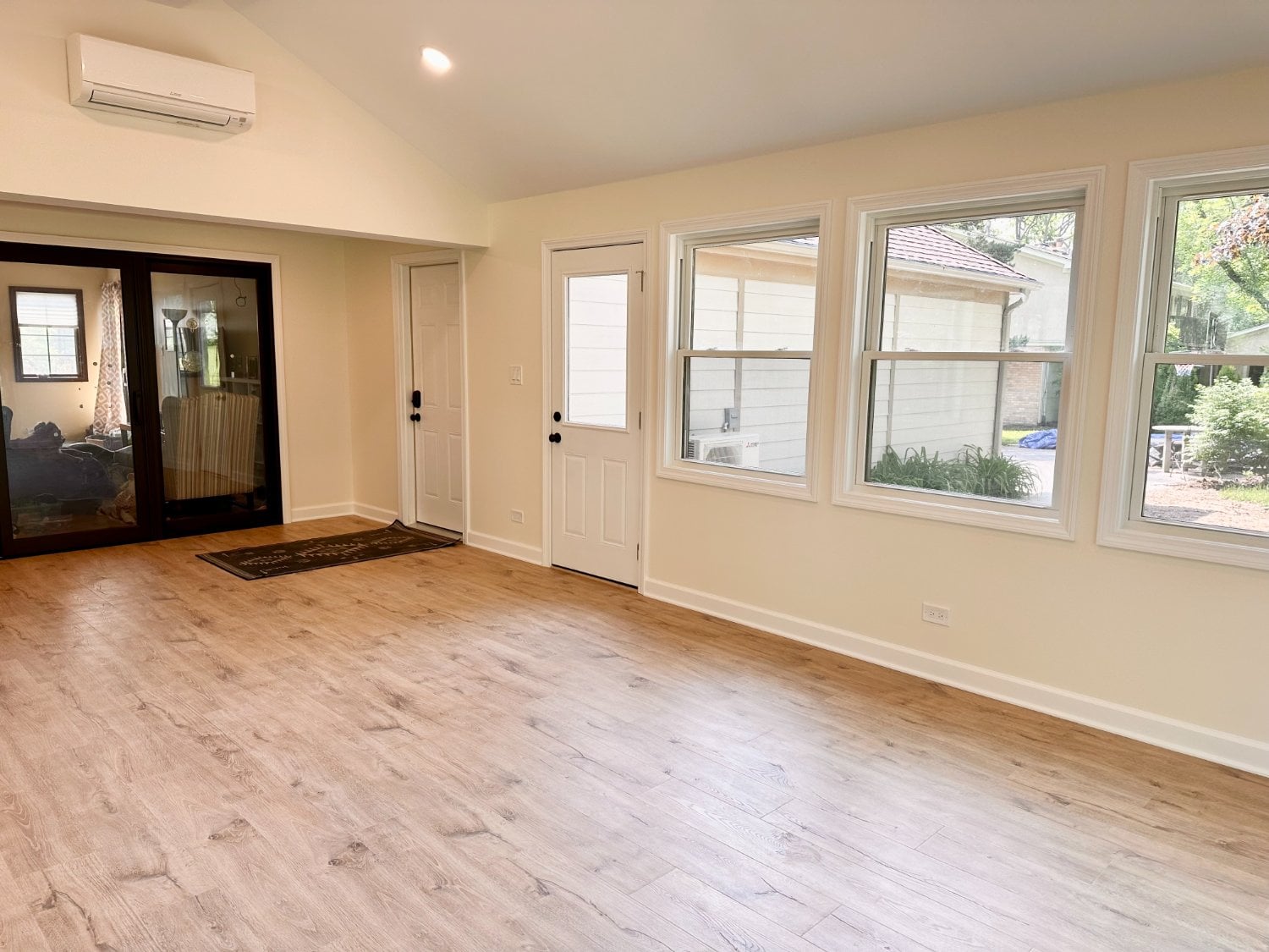 Skor Construction 3 seasons room in Inverness, IL featuring large windows, luxury vinyl flooring, and modern exterior access doo-optimized
