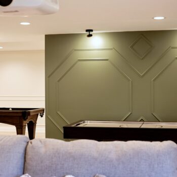 Back view of basement remodel and green paneled wall in basement remodel in North Barrington by Skor Construction
