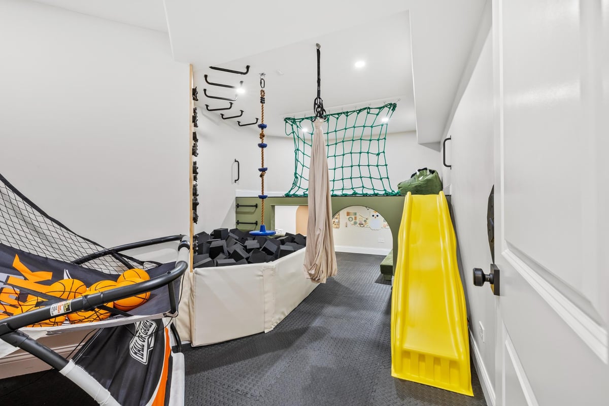Custom kids play area in basement remodel by Skor Construction