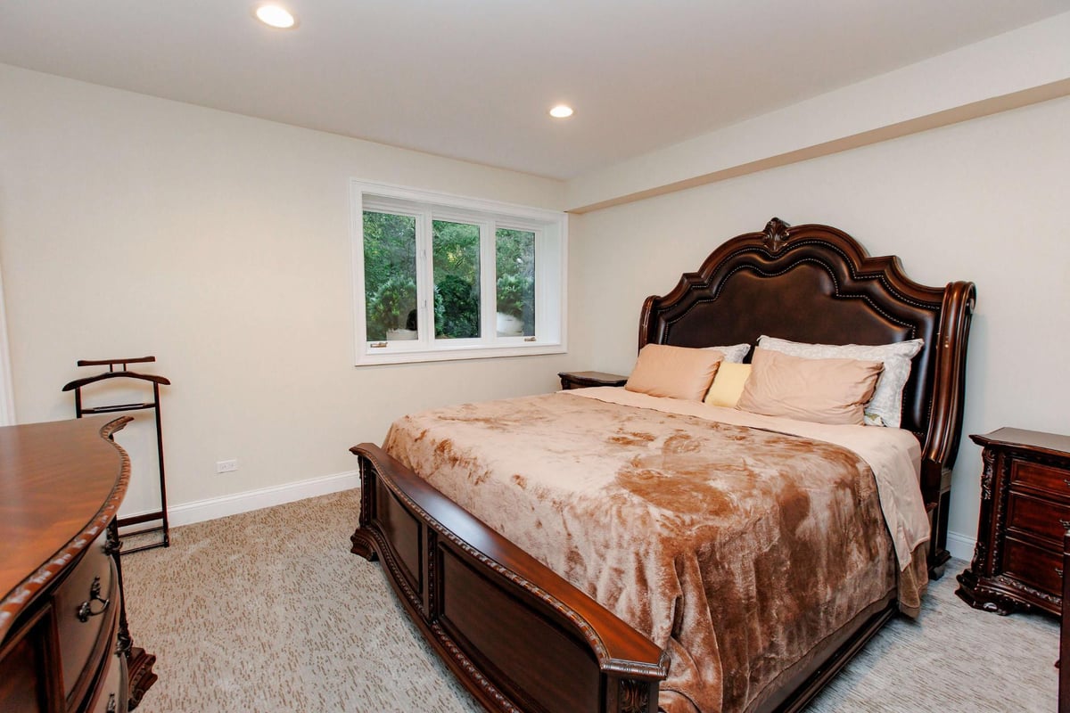 Optimized bedroom in basement by Skor Construction in North Barrington