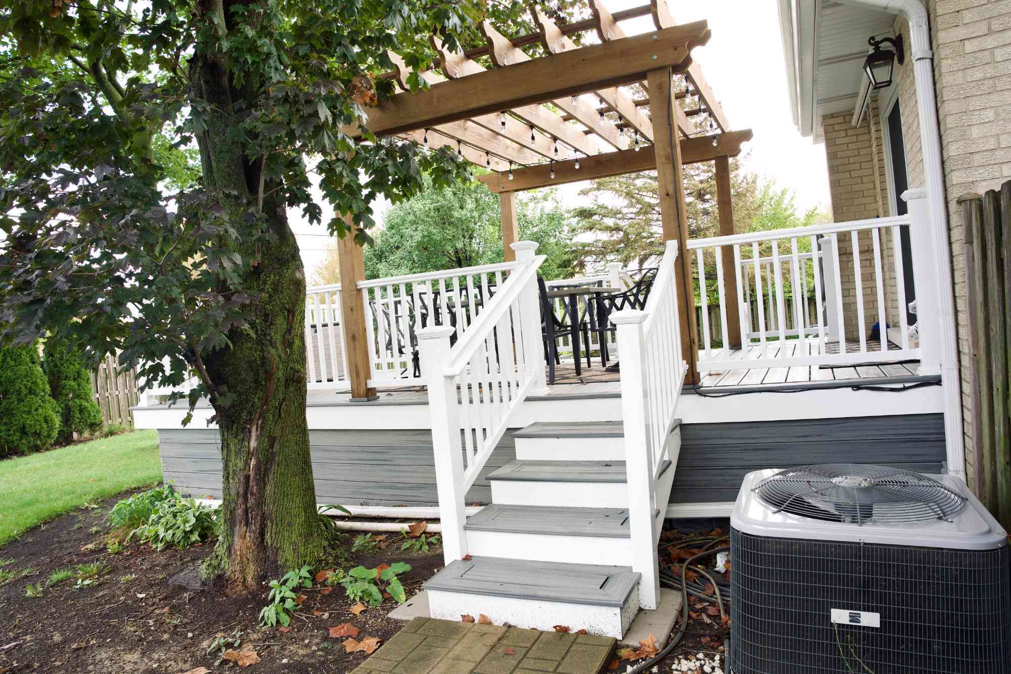 elevated deck and pergola built by Skor Construction in Mount Prospect, IL featuring composite stairs, white railings, and outdo-optimized