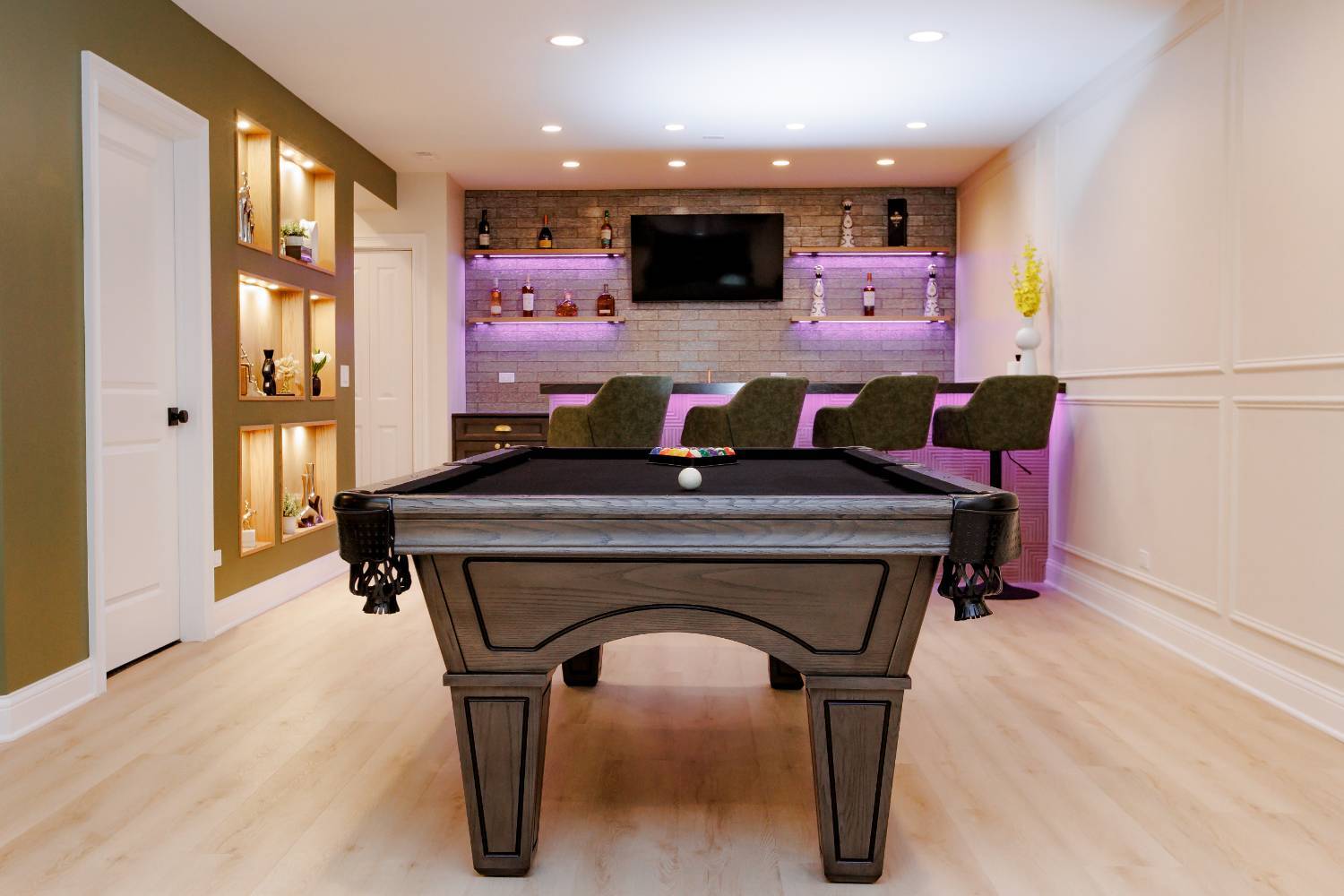 entertainment-focused basement renovation featuring billiards, bar seating, and stone accent wall by Skor Construction in Palati-optimized