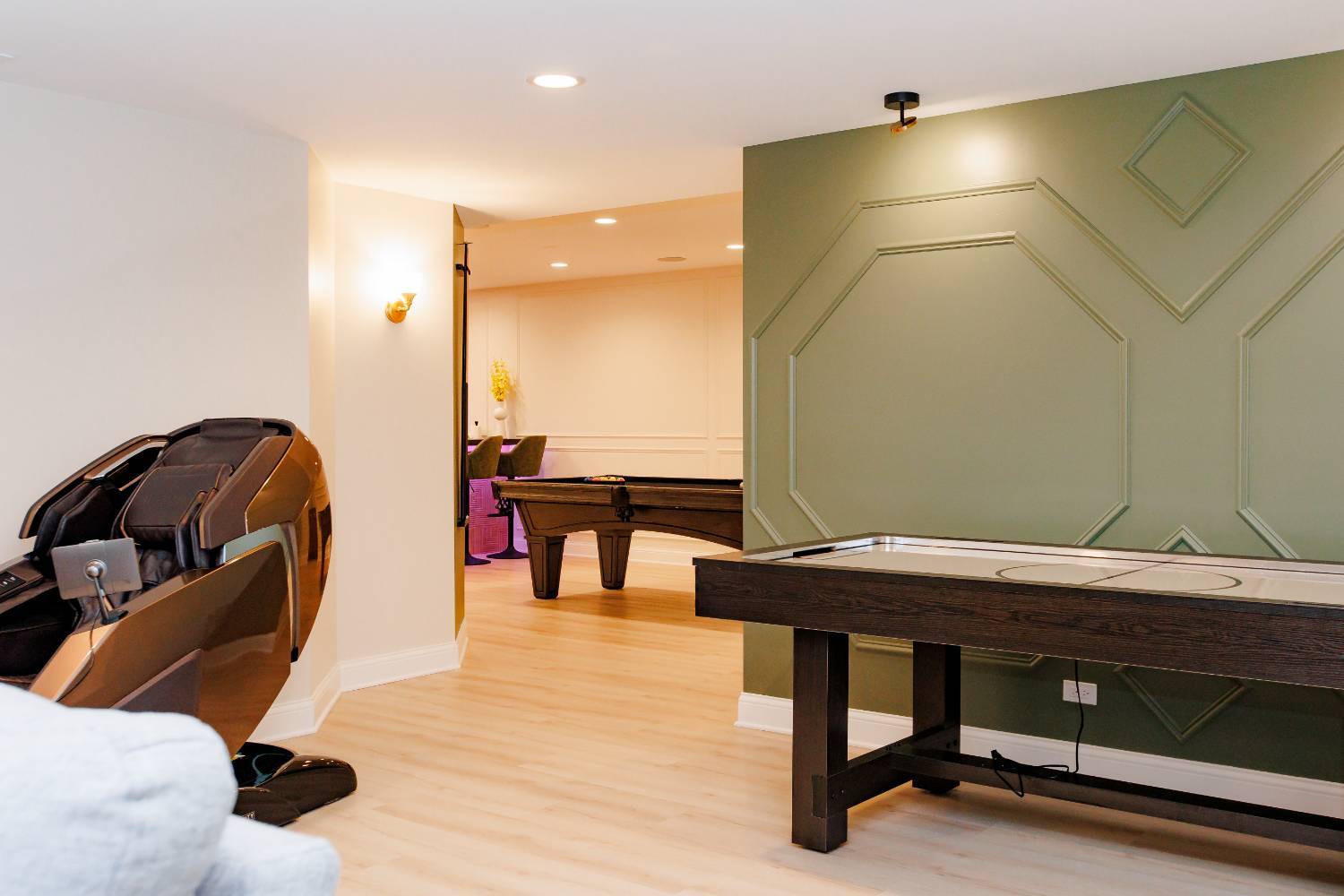 finished basement recreation area featuring entertainment amenities and decorative wall molding by Skor Construction in Palatine-optimized
