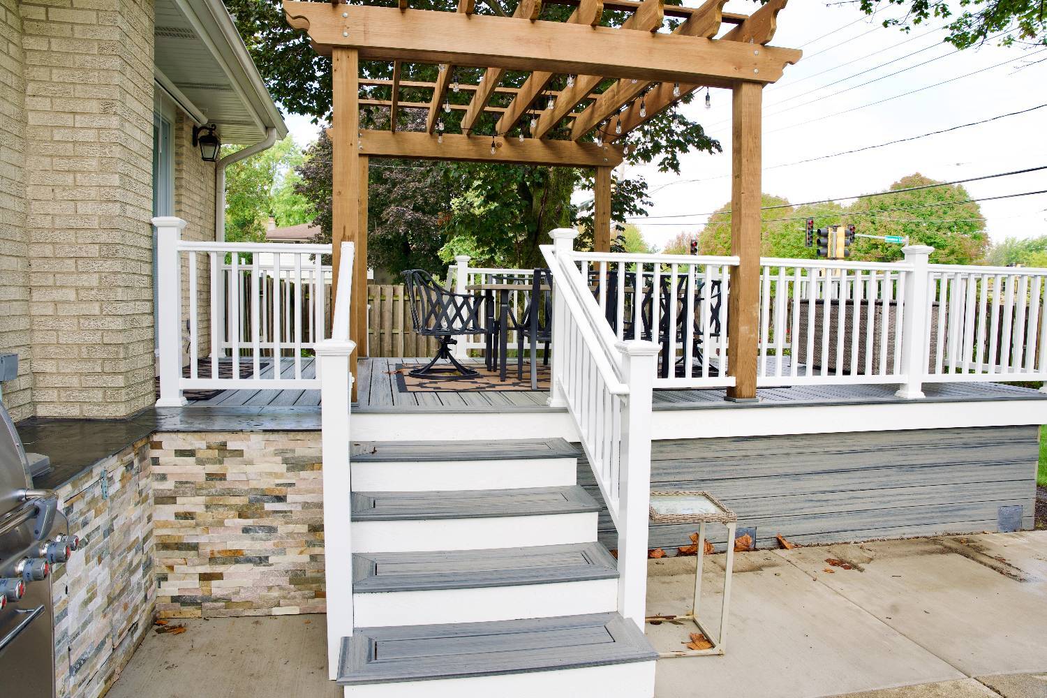outdoor living space by Skor Construction in Mount Prospect, IL with a wood pergola, spacious deck, and upgraded backyard access-optimized