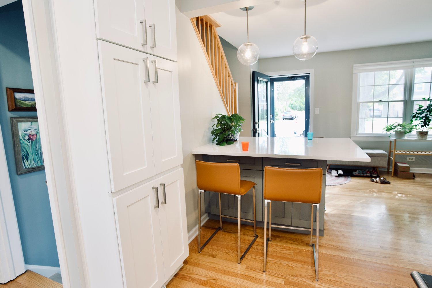 custom kitchen island with seating and floor-to-ceiling pantry cabinetry remodeled by Skor Construction in Mount Prospect, IL.-optimized