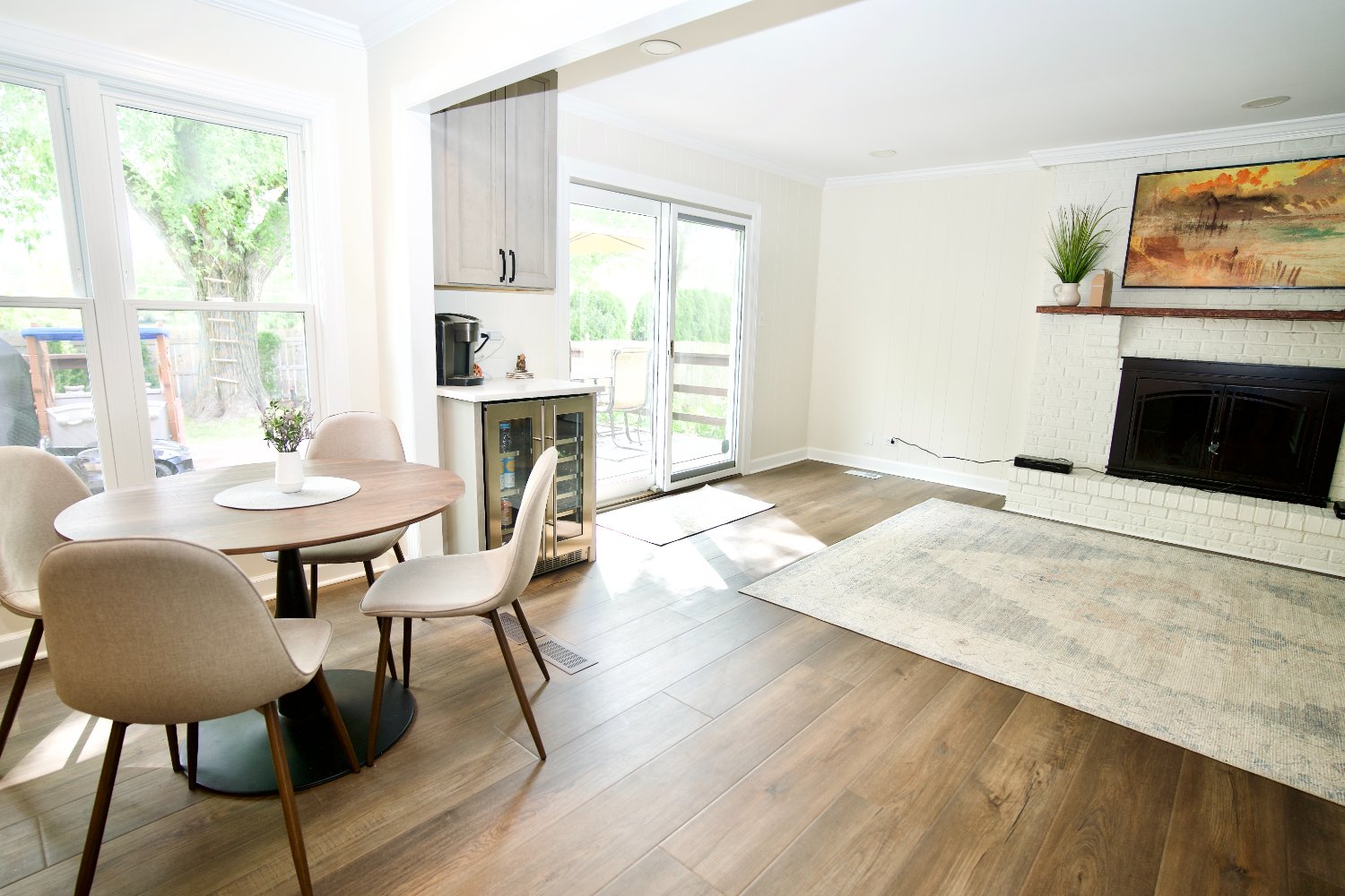 updated dining space with hardwood-look flooring, fireplace, and patio access completed by Skor Construction in Arlington Height-optimized