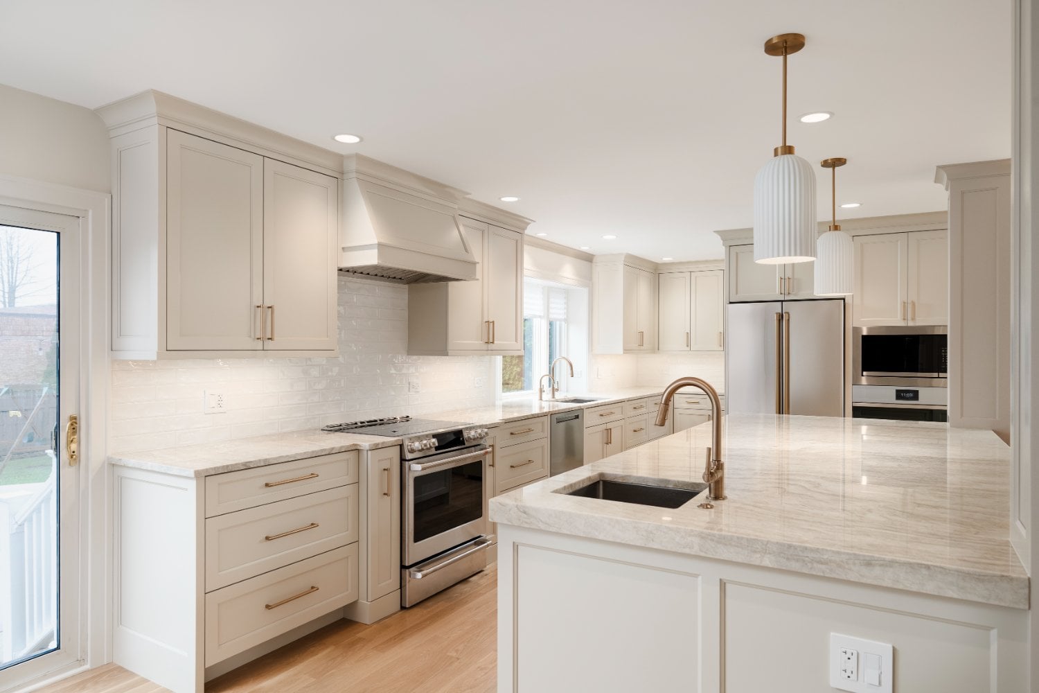 Skor Construction custom kitchen remodel in Mount Prospect, IL, featuring a large quartz island, white shaker cabinets, and stain-optimized