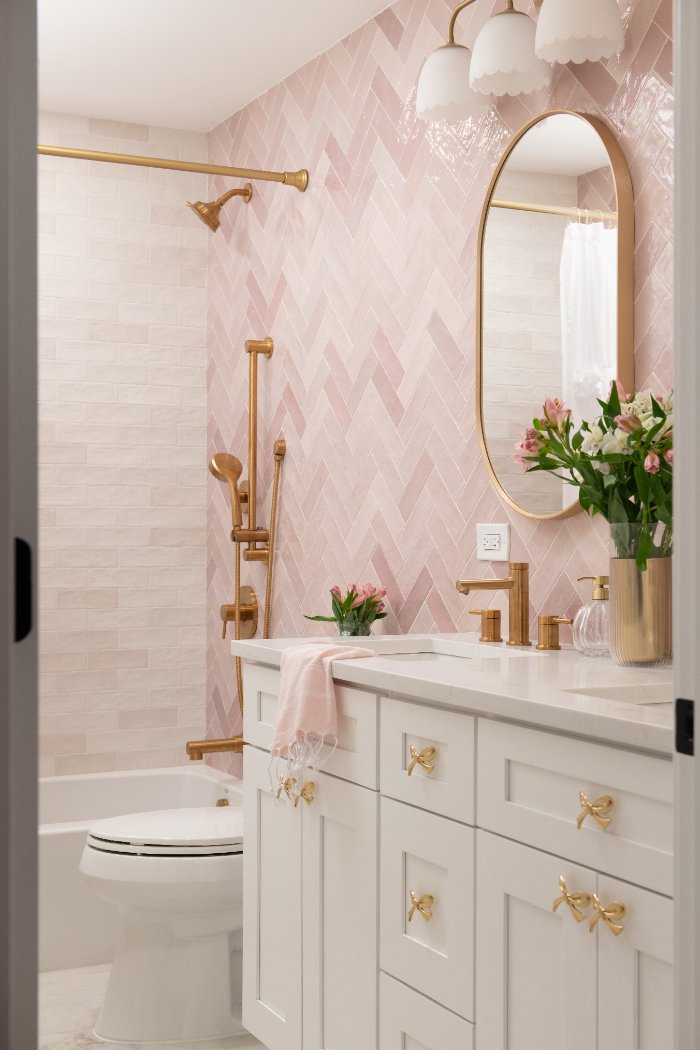 luxury bush bathroom design by Skor Construction in Mount Prospect, IL featuring blush tile walls and gold hardware.-optimized
