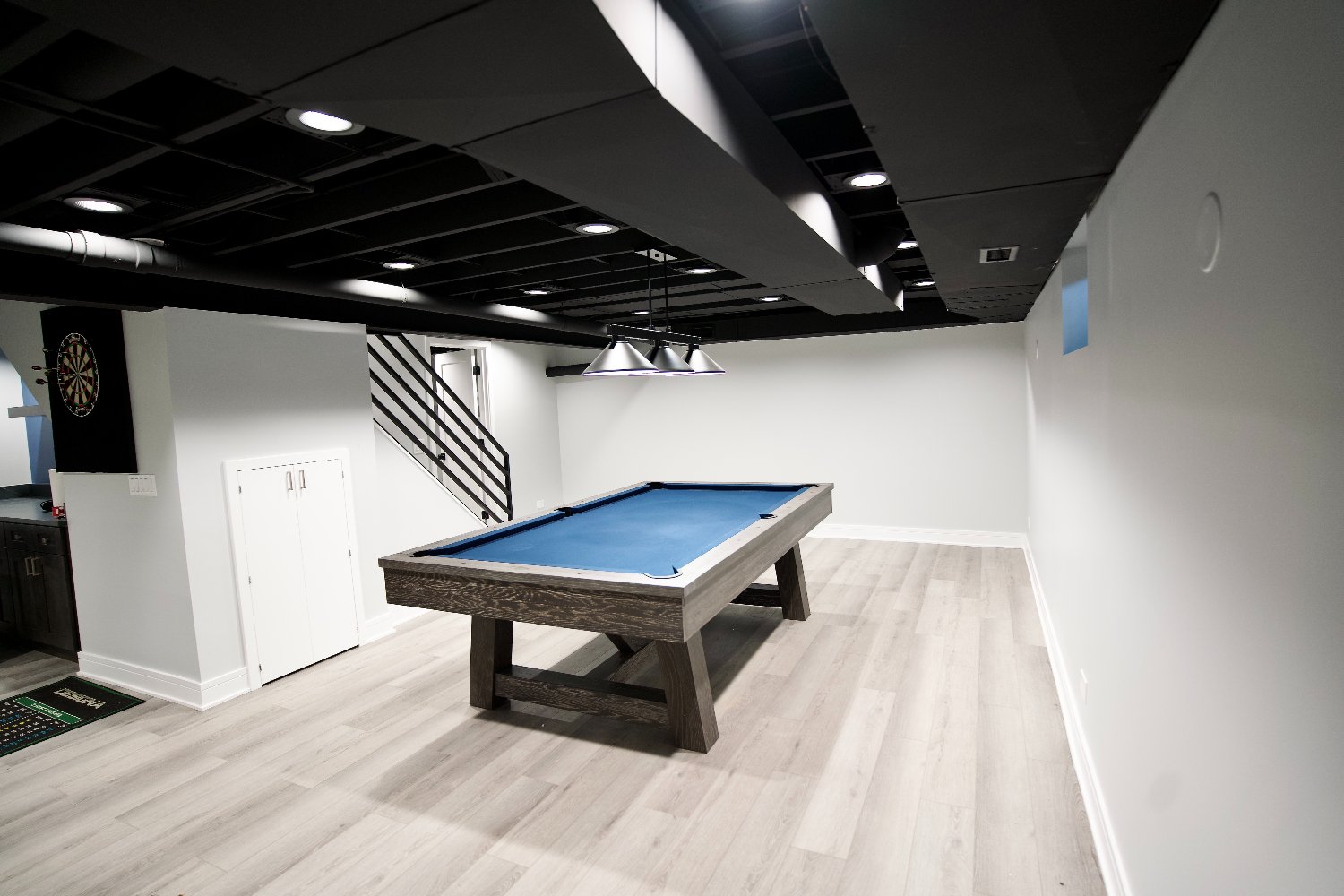 luxury basement remodel in Riverwoods, IL by Skor Construction featuring a billiards space and contemporary finishes.-optimized