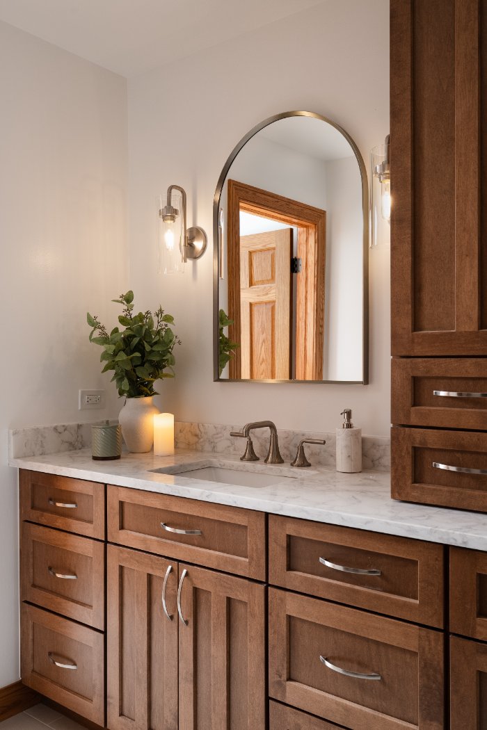 Detailed view of a luxury primary bathroom remodel by Skor Construction in Inverness, IL with marble surfaces and custom storage-optimized
