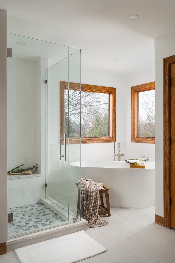 Luxury bathroom retreat by Skor Construction in Inverness, IL showcasing a freestanding bathtub and modern glass shower enclosur-optimized