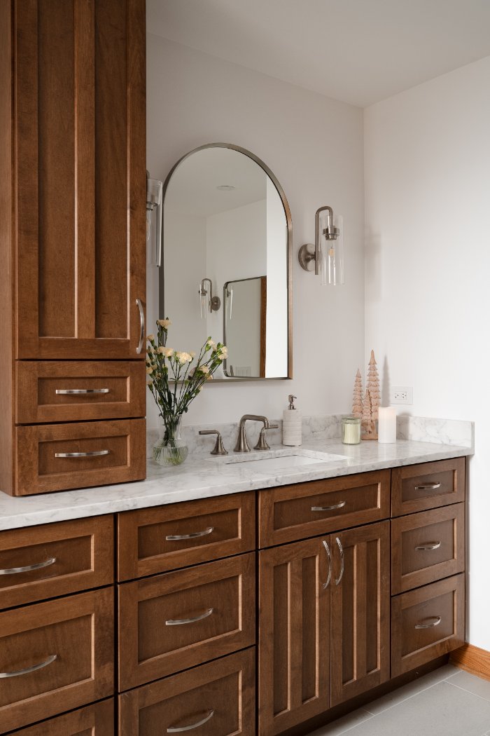 Skor Construction Lauder Primary Bathroom Remodel in Inverness, IL showcasing a dual sink vanity with walnut cabinetry and marbl-optimized