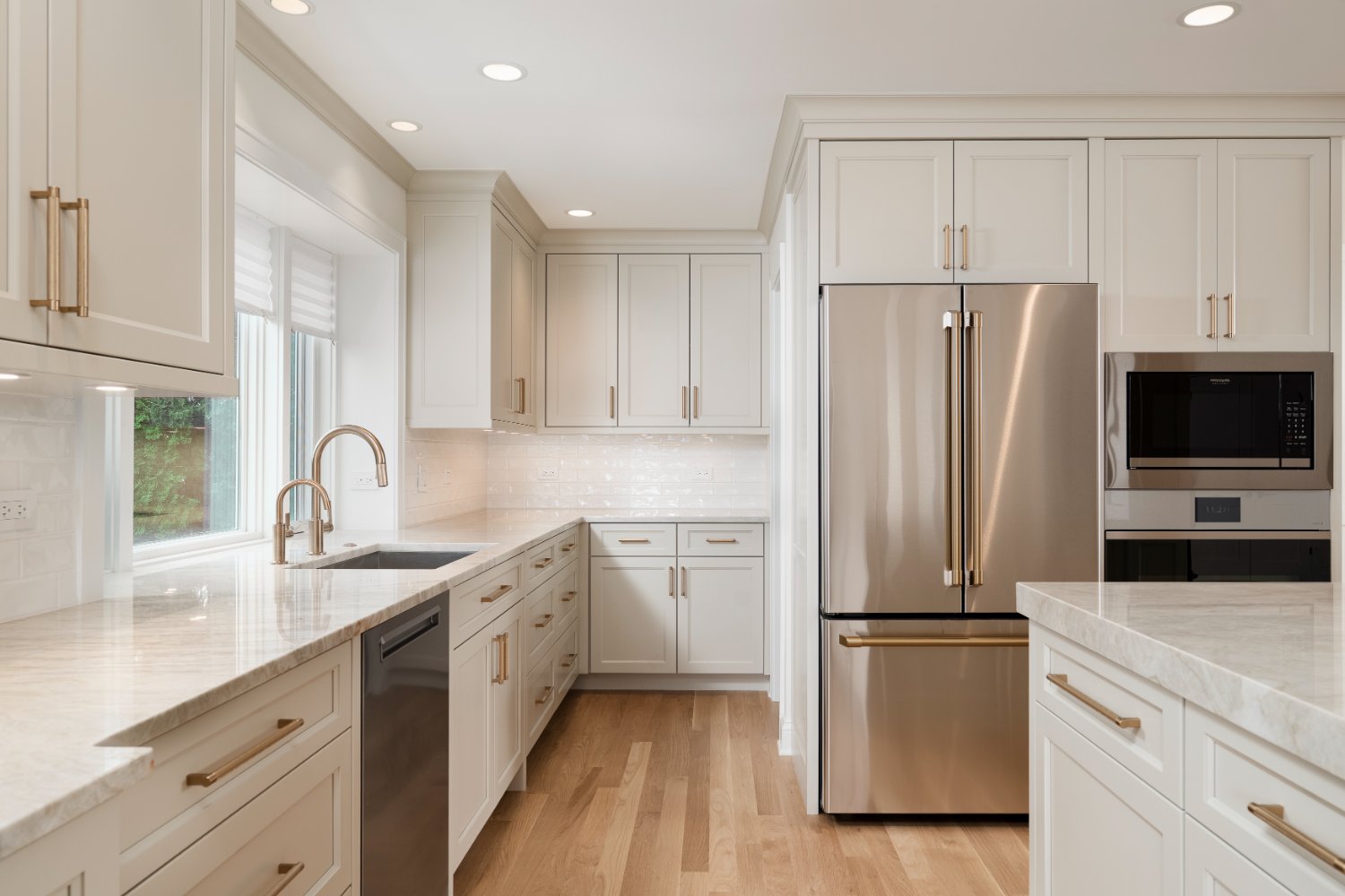Bright open-concept kitchen remodel by Skor Construction in Mount Prospect, IL featuring a large refrigerator, built-in microwav-optimized