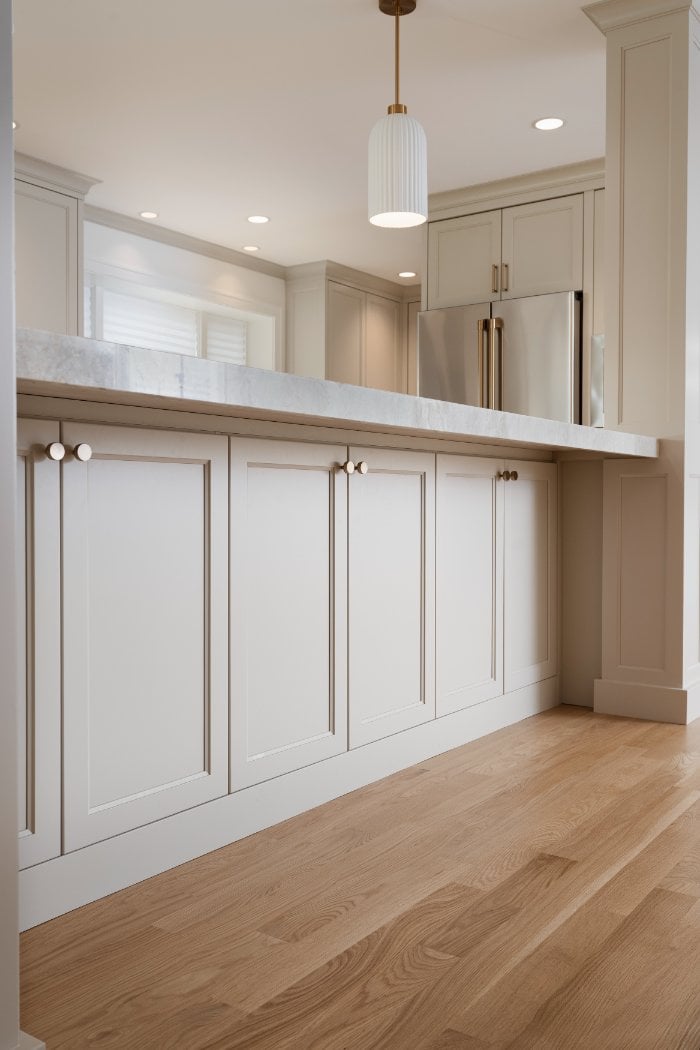 Custom kitchen island remodel by Skor Construction in Mount Prospect, IL with decorative millwork, brass hardware, and hardwood -optimized