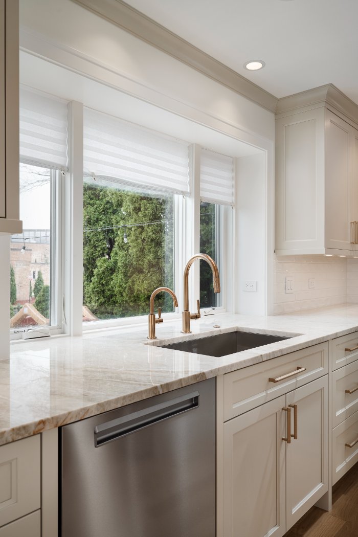 Elegant kitchen renovation by Skor Construction in Mount Prospect, IL with custom cabinetry, stainless steel dishwasher, and nat-optimized