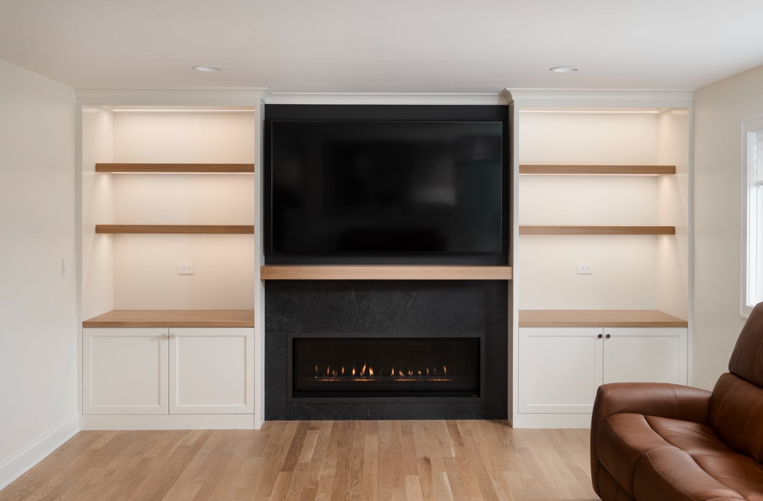 Skor Construction family room renovation in Mount Prospect, IL with custom built-in shelving, modern fireplace surround, and mou-optimized
