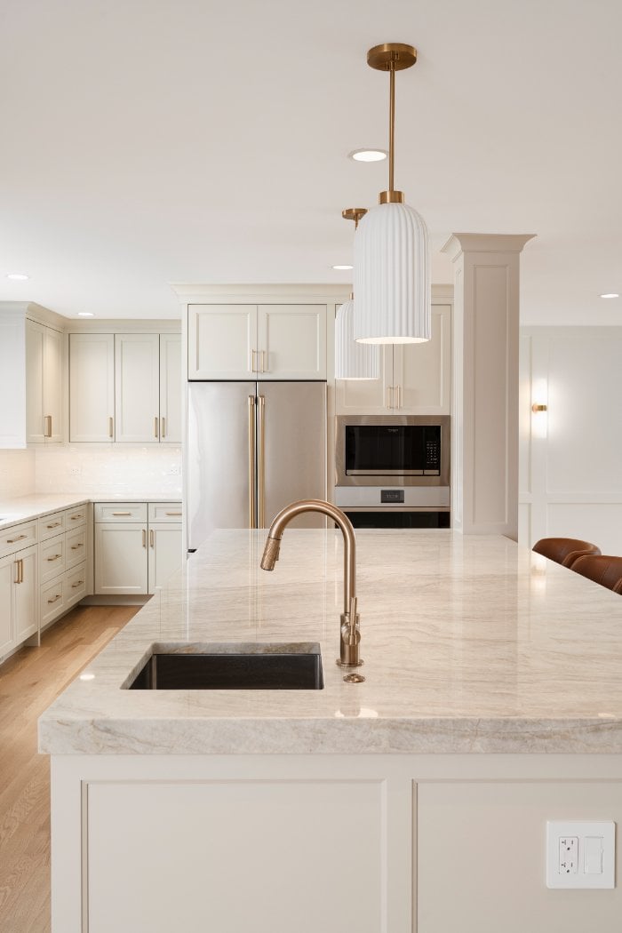 Skor Construction kitchen remodel in Mount Prospect, IL featuring a quartz island, brass faucet, and custom white shaker cabinet-optimized