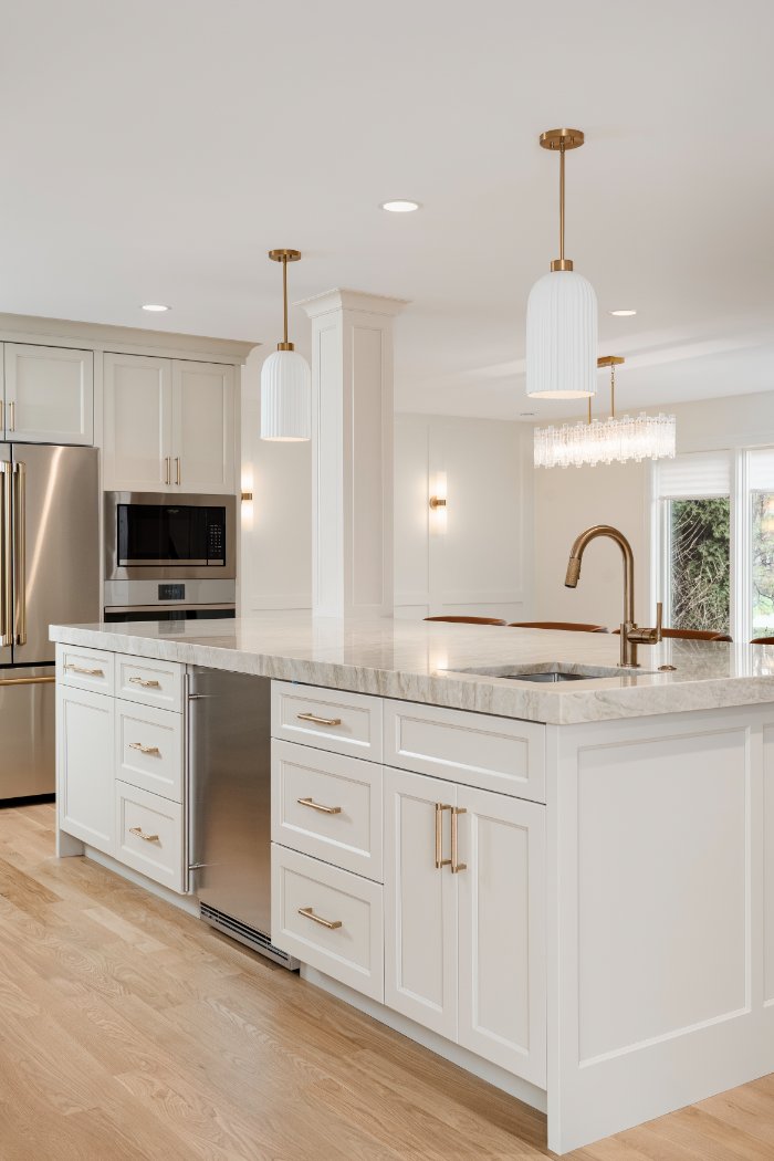 Skor Construction main level kitchen renovation in Mount Prospect, IL featuring a large quartz island with integrated sink and b-optimized