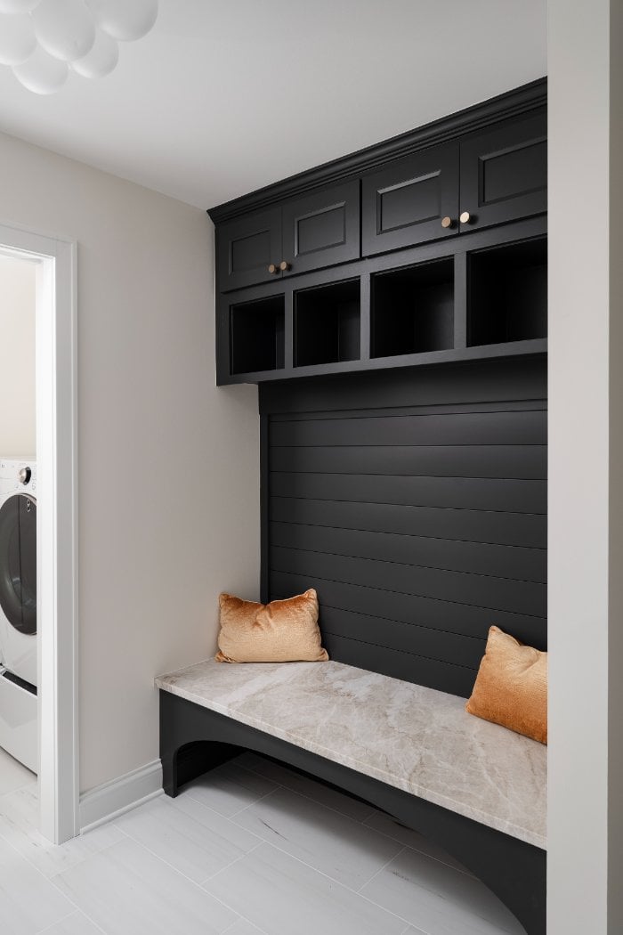 Skor Construction mudroom renovation in Mount Prospect, IL featuring custom black built-in lockers, marble bench seating, and mo-optimized