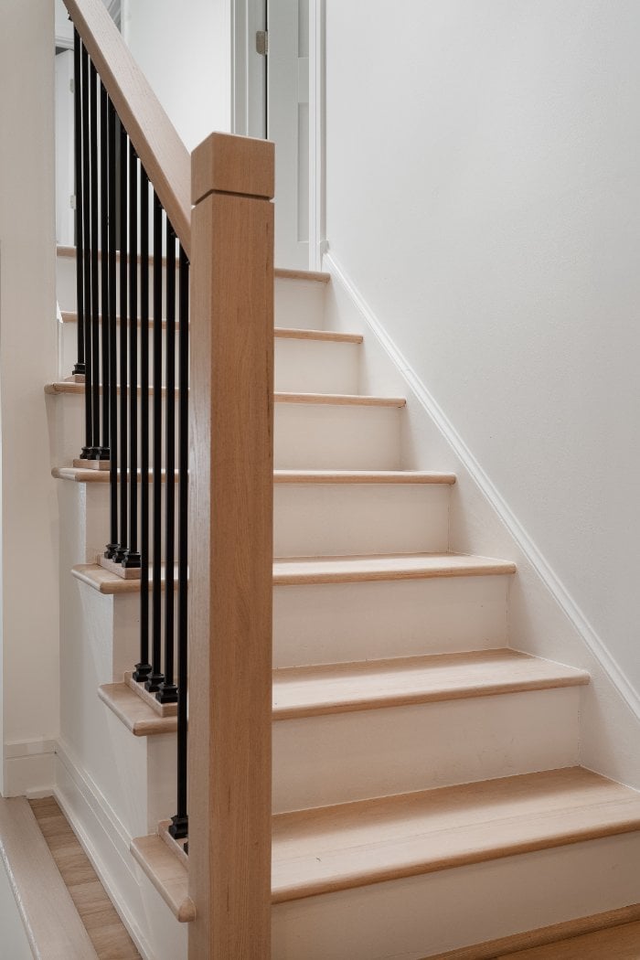 Main level staircase renovation in Arlington Heights, IL completed by Skor Construction showcasing modern railing design and har-optimized