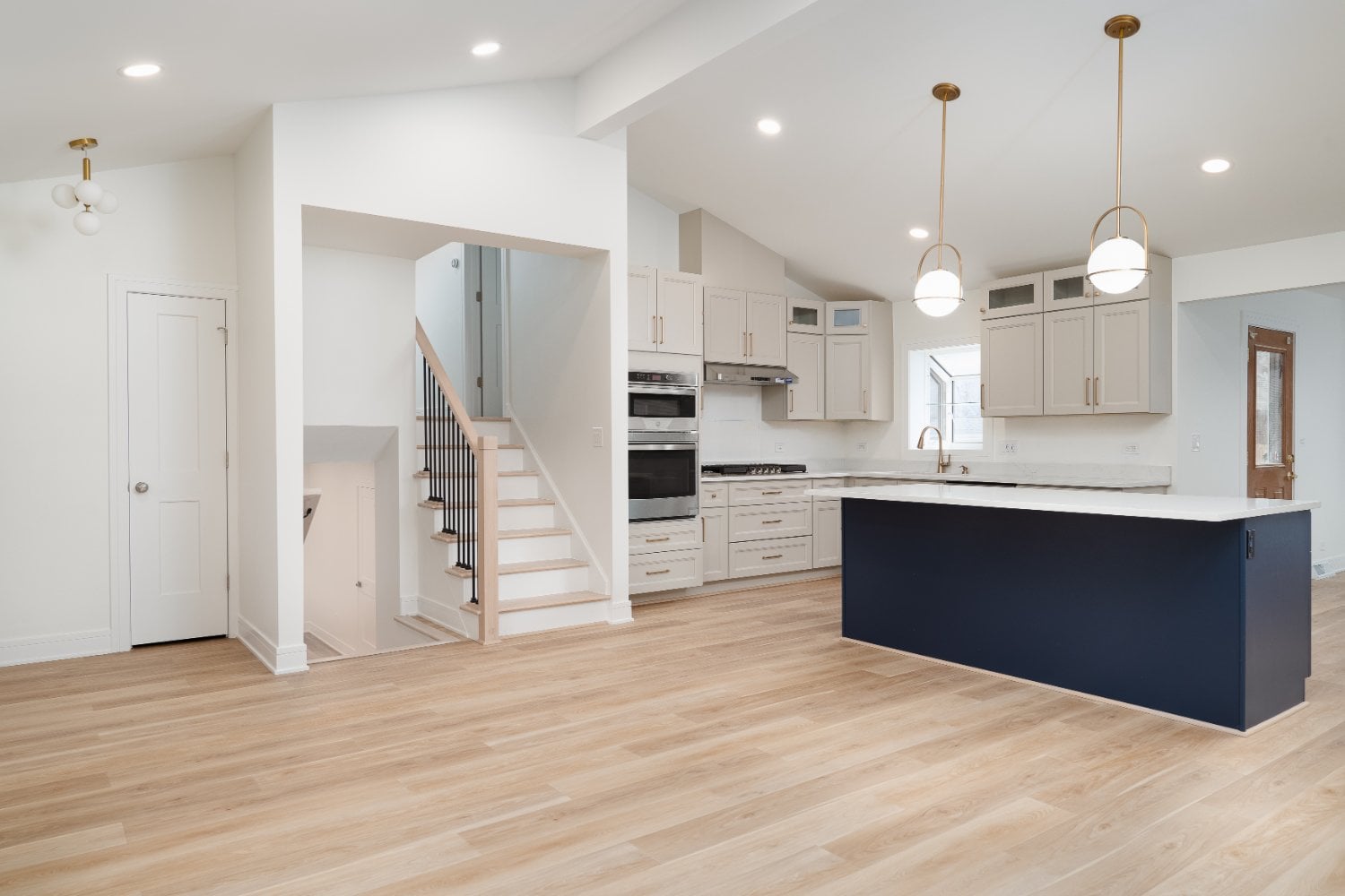 Open-concept kitchen renovation in Arlington Heights, IL completed by Skor Construction showcasing hardwood floors and custom na-optimized