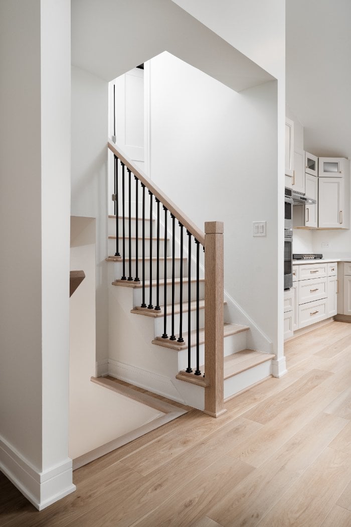 Skor Construction staircase renovation in Arlington Heights, IL featuring natural wood stair treads and modern black iron balust-optimized