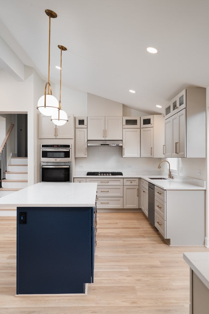 Spacious kitchen remodel by Skor Construction in Arlington Heights, IL with custom shaker cabinetry and contrasting navy island -optimized