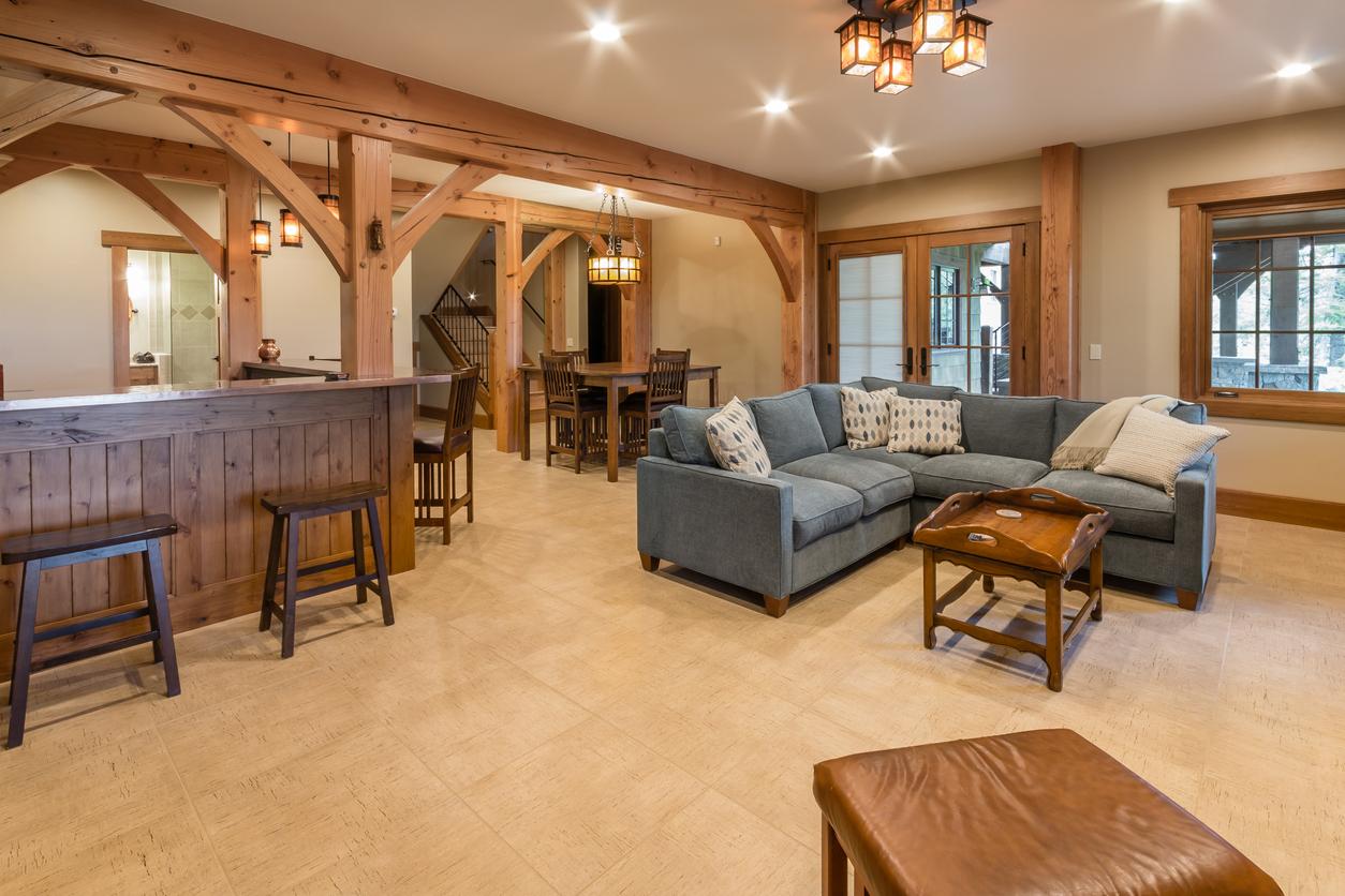 A finished basement with counters, a couch and seating to host large parties